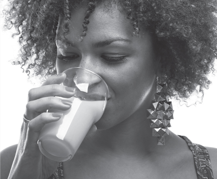 Image of a lady drinking a glass of orange juice